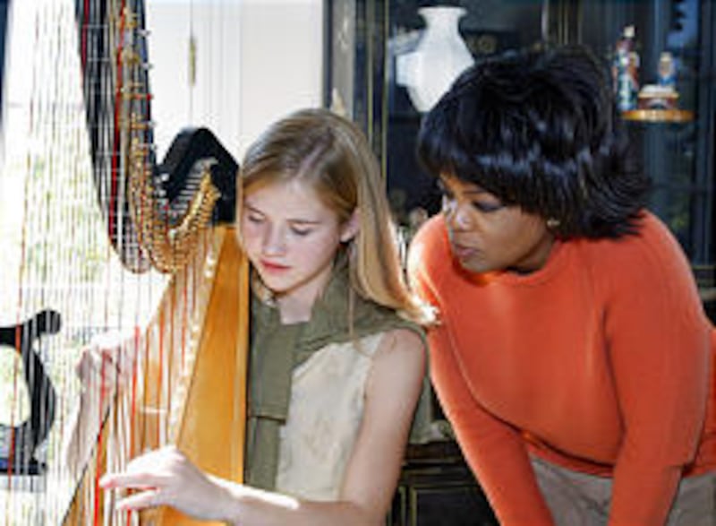 Oprah Winfrey leans in for a private harp performance from Elizabeth Smart.