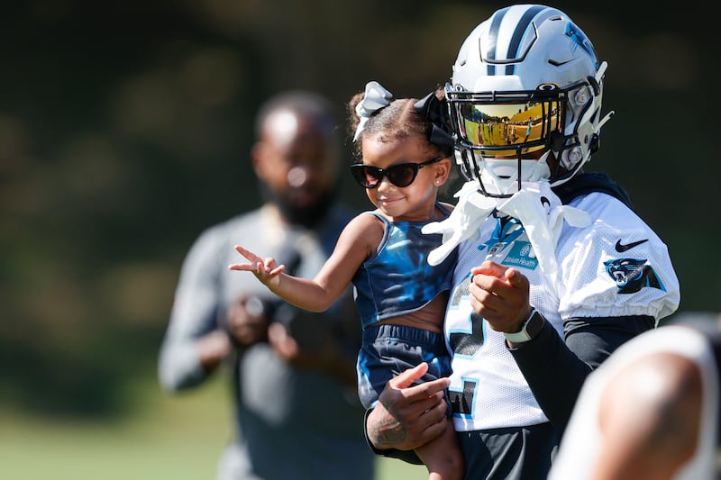 Carolina Panthers wide receiver DJ Moore holds his daughter at his team’s training camp at Wofford College in Spartanburg, S.C., Thursday, July 28, 2022.