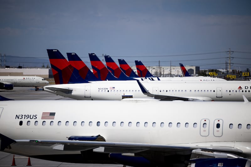 Delta Air Lines jets are parked at their gates at the Salt Lake City International Airport in Salt Lake City on July 1, 2022.