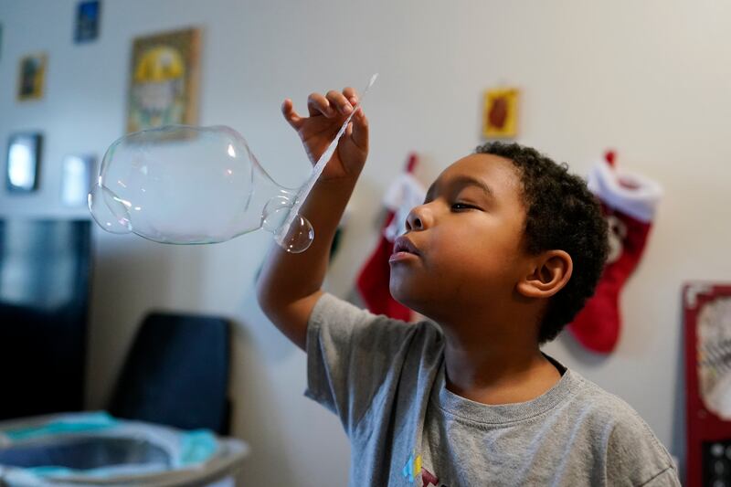 Elijah Hill plays with his bubbles on Dec. 9, 2023, in Westfield, Ind.