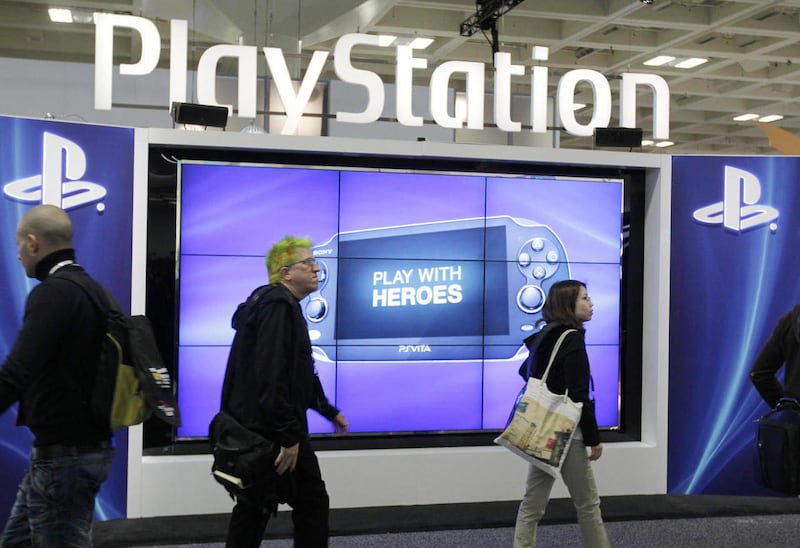 FILE- This March 8, 2012 file photo shows attendees walking past the Sony PlayStation PS Vita console on display in the Sony PlayStation booth at the Game Developers Conference in San Francisco. Sony’s PlayStation Network service for video games was unusa