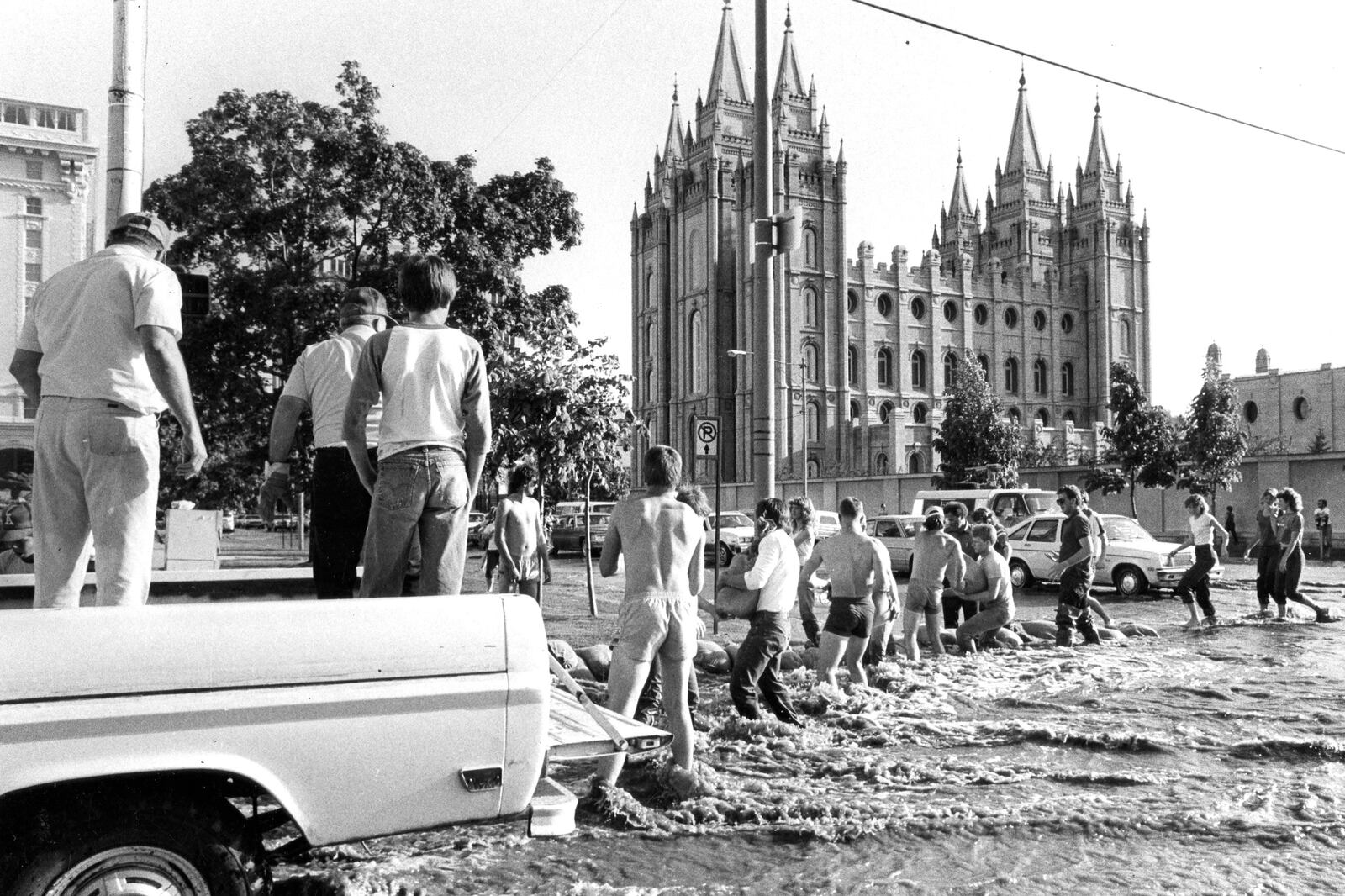 Volunteers build a temporary dike along Main Street near the Salt Lake Temple.