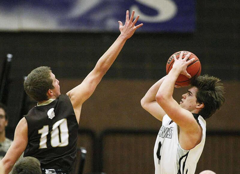 Davis' Jesse Wade tries to disrupt a shot by Alta's Zach Rollins as Alta and Davis play Tuesday, Dec. 3, 2013 in Sandy. Alta won 67-55.