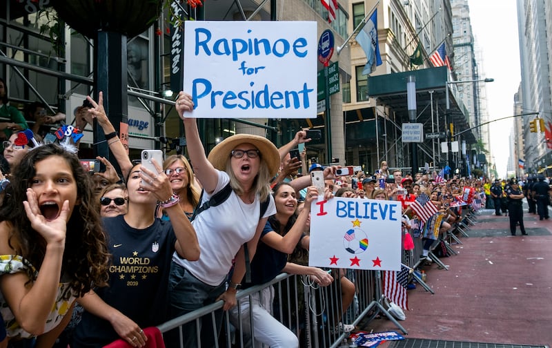 Fans celebrates as members of the the U.S. women's soccer team approach during a ticker tape parade along the Canyon of Heroes, Wednesday, July 10, 2019 in New York. The U.S. national team beat the Netherlands 2-0 to capture a record fourth Women's World