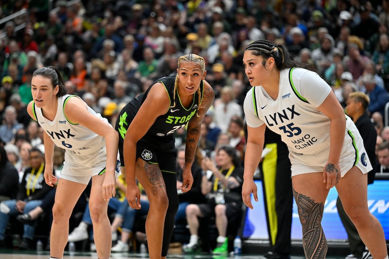 Minnesota Lynx forward Bridget Carleton (6) and forward Alissa Pili (35), and Seattle Storm center Mercedes Russell (21) line up during a free throw during game, Tuesday, May 14, 2024, in Seattle.