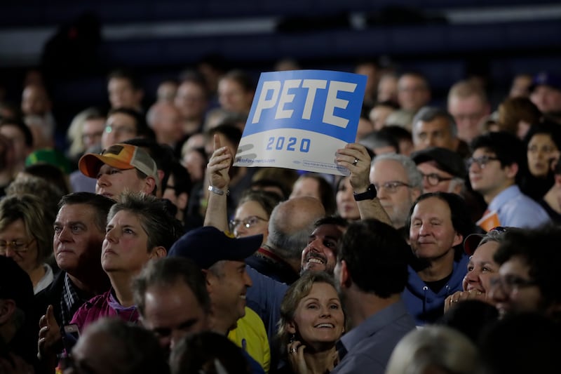 A supporters of Democratic presidential candidate former South Bend, Ind. Mayor Pete Buttigieg holds up a “PETE 2020” campaign sign at a primary night election rally in Nashua, N.H., Tuesday Feb. 11, 2020.