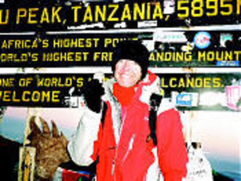 Michael Hannan of Salt Lake City stands on the summit of Mount Killimanjaro holding his first defibrillator. He has climbed the peak twice.