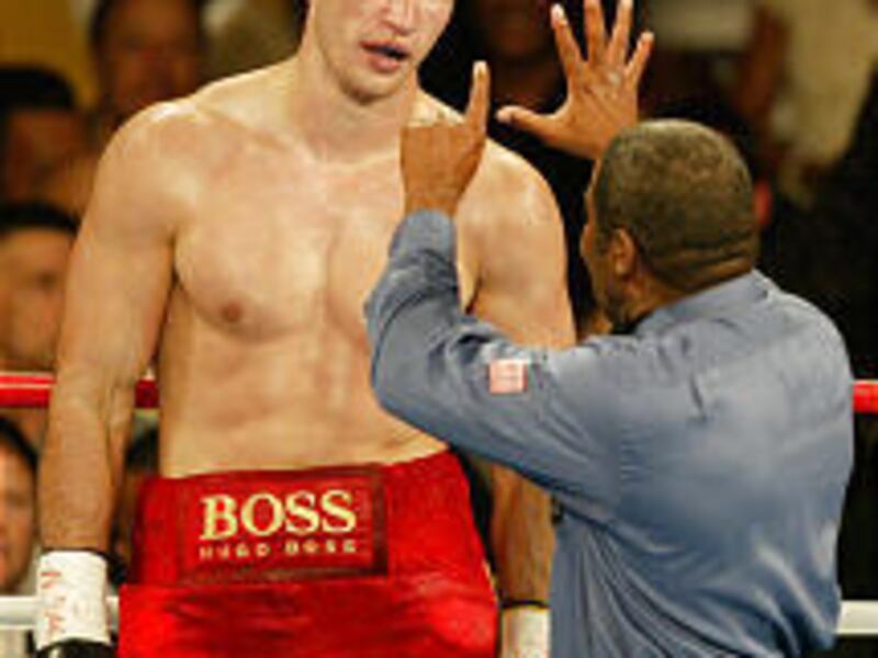 Wladimir Klitschko takes a standing 8-count from referee Robert Byrd in Saturday's bout in Las Vegas.