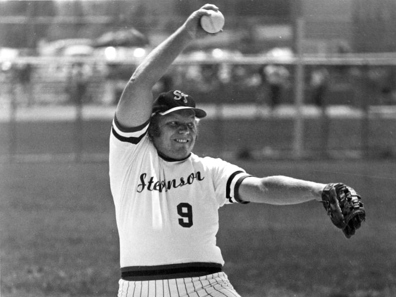 Larry H. Miller is pictured winding up to pitch during a fast pitch softball game in this undated photo.