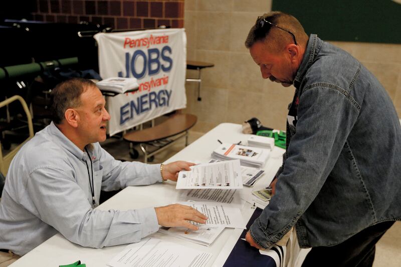 FILE - In this Thursday, Nov. 2, 2017, photo, a recruiter in the shale gas industry, left, speaks with an attendee of a job fair in Cheswick, Pa. Employers in the United States are thought to have kept up their brisk pace of hiring in June 2018, reflectin