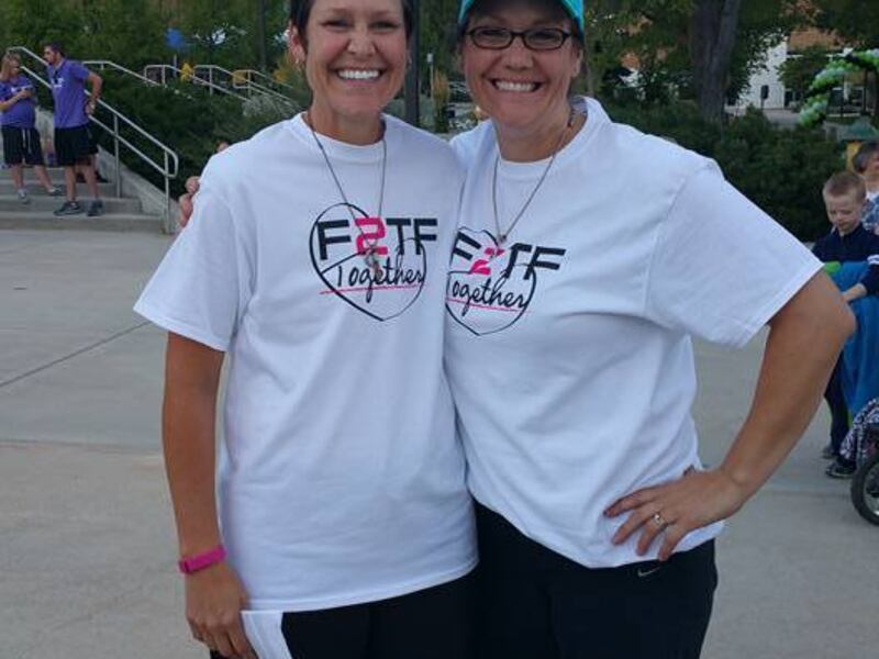 Becky Anderson, left, and Brenda Smith, right, pose at the 4th annual F2TF 5K in honor of Tyler Smith, an Anything for a Friend recipient, whose mantra was "Fight to the Finish."