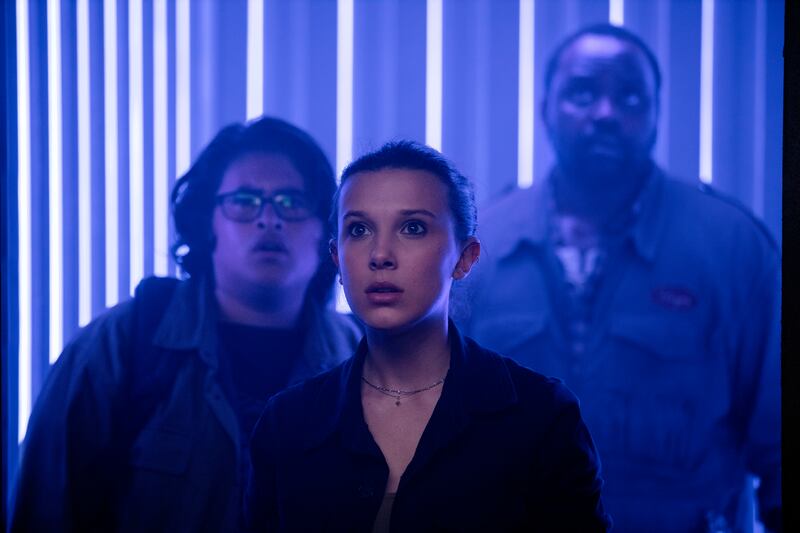 This image released by Warner Bros. Entertainment shows Millie Bobby Brown, center, Julian Dennison, left, and Brian Tyree Henry in a scene from “Godzilla vs. Kong.”