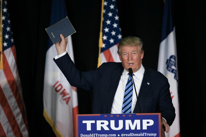 Republican presidential candidate Donald Trump holds up his bible during a campaign stop in Council Bluffs, Iowa, Tuesday, Dec. 29, 2015. (AP Photo/Nati Harnik)