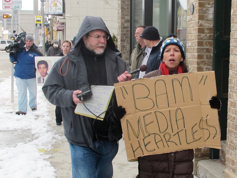 Janie Hagen protests in Milwaukee against Bam Marketing and Media.