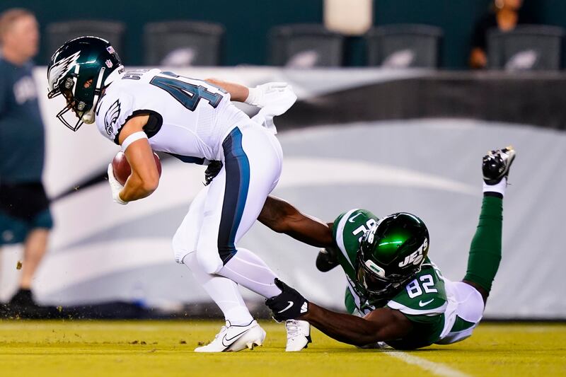 New York Jets’ Irvin Charles, right, tackles Philadelphia Eagles’ Britain Covey during the second half of a preseason NFL football game.