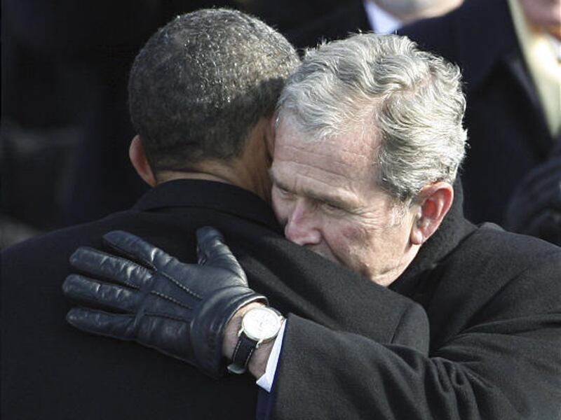 Former President George W. Bush, right, hugs President Barack Obama after Obama was sworn in at the U.S. Capitol in Washington Tuesday.