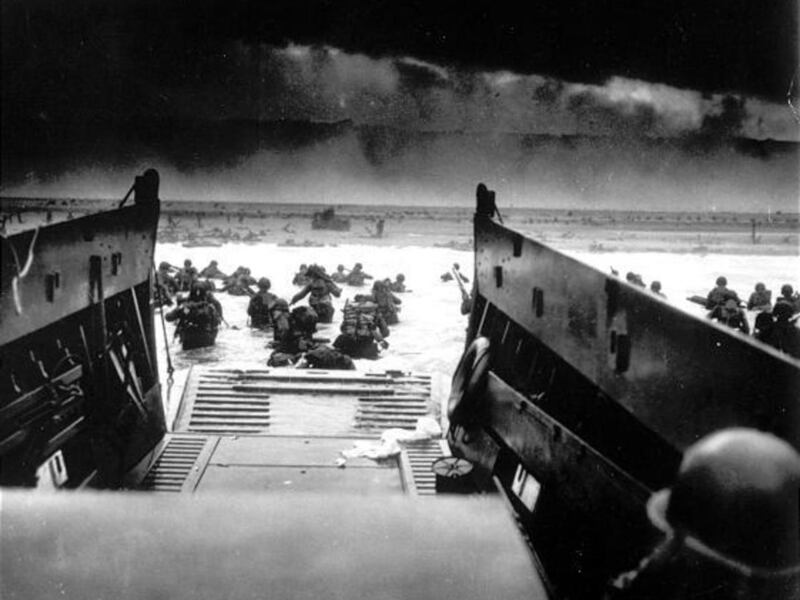 American soldiers wade ashore from their landing craft during the Allies' D-Day operations at Normandy.