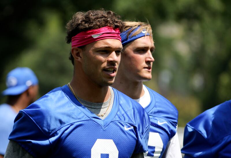 BYU QBs Jaren Hall and Rhett Reilly, wearing blue jerseys, leave practice.