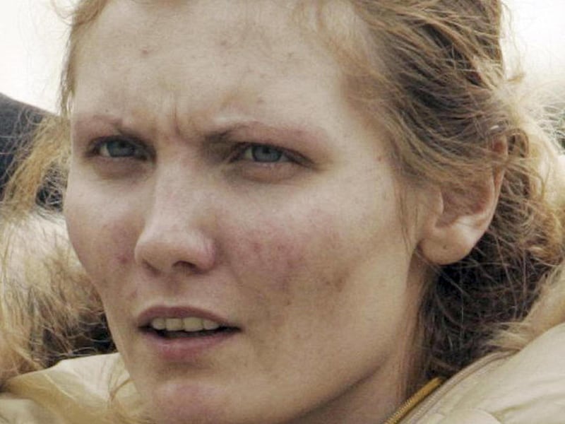 FILE - This Feb. 8, 2005 photo shows Nicole Pearce as she is escorted into police headquarters in Mineola, N.Y.  Pearce, originally from California, died Oct. 7, 2011 while serving time at the York Correctional Center in Nyantic, Conn., for her role in a
