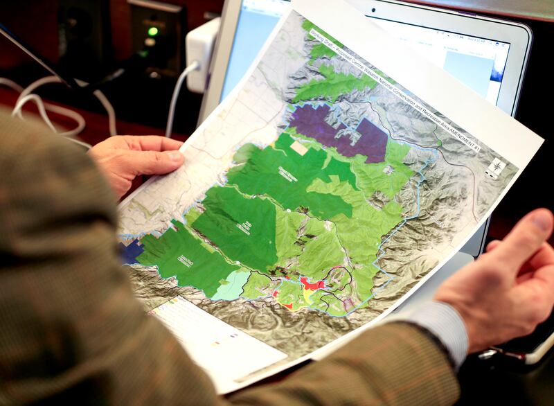 Rep. Joel Briscoe, D-Salt Lake City, holds a map of the proposed federal designation legislation creating a Central Wasatch Conservation and Recreation Area during the Commission for the Stewardship of Public Lands meeting at the Utah State Capitol in Sal