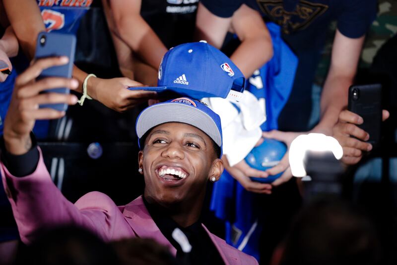 RJ Barrett poses for selfies with fans after he was selected by the New York Knicks at the NBA basketball draft Thursday, June 20, 2019, in New York. Barrett was selected third overall. (AP Photo/Julio Cortez)