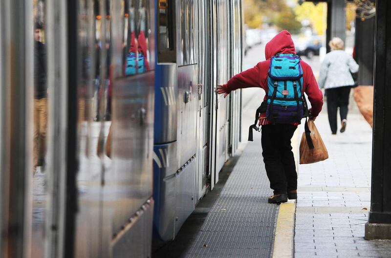 A passenger boards a UTA Trax train in downtown Salt Lake City Wednesday, Oct. 30, 2013. The Utah Transit Authority will be giving away iPads to college students who use their student passes to travel to and from campus.