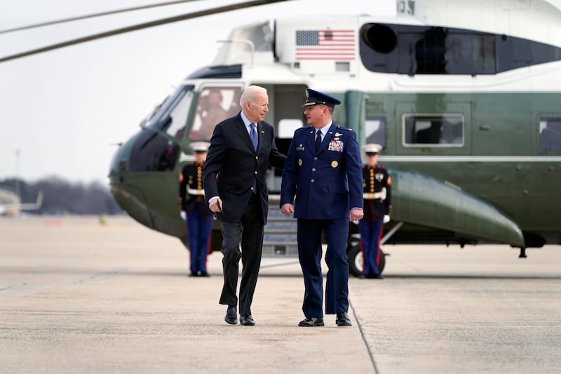President Joe Biden is escorted to Air Force One by Col. Matthew Jones, commander of 89th Airlift Wing.