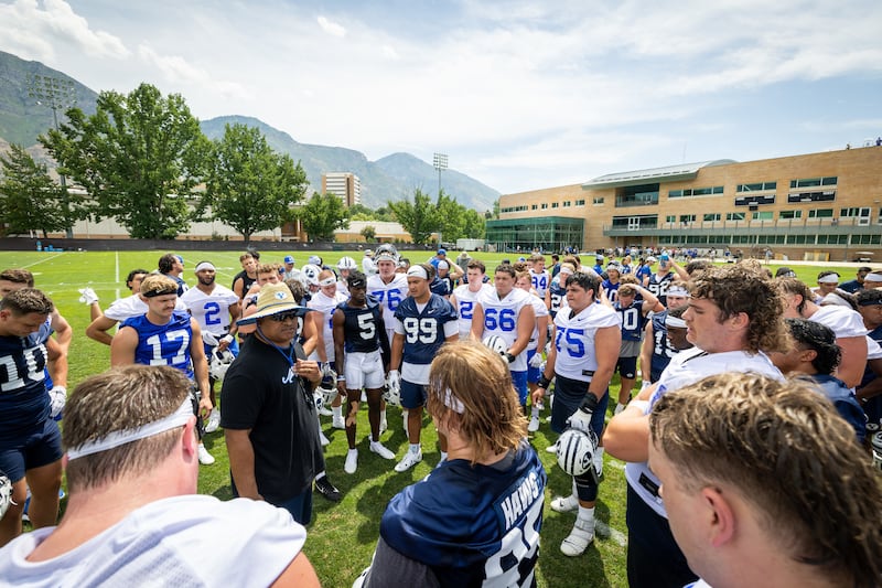 BYU football coach Kalani Sitake talks to his players during BYU’s first day of fall camp on Thursday, Aug. 4, 2022.
