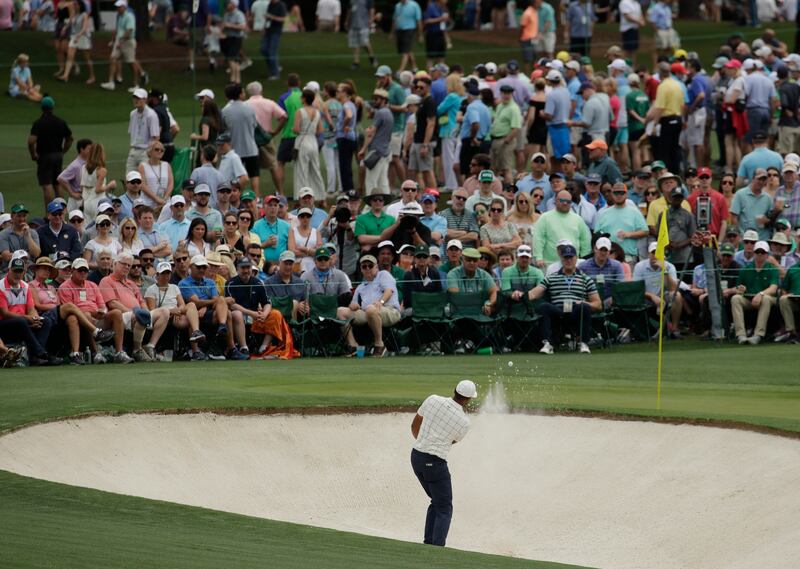 Tony Finau hits from a bunker on the second hole during the third round for the Masters golf tournament Saturday, April 13, 2019, in Augusta, Ga. (AP Photo/Charlie Riedel)