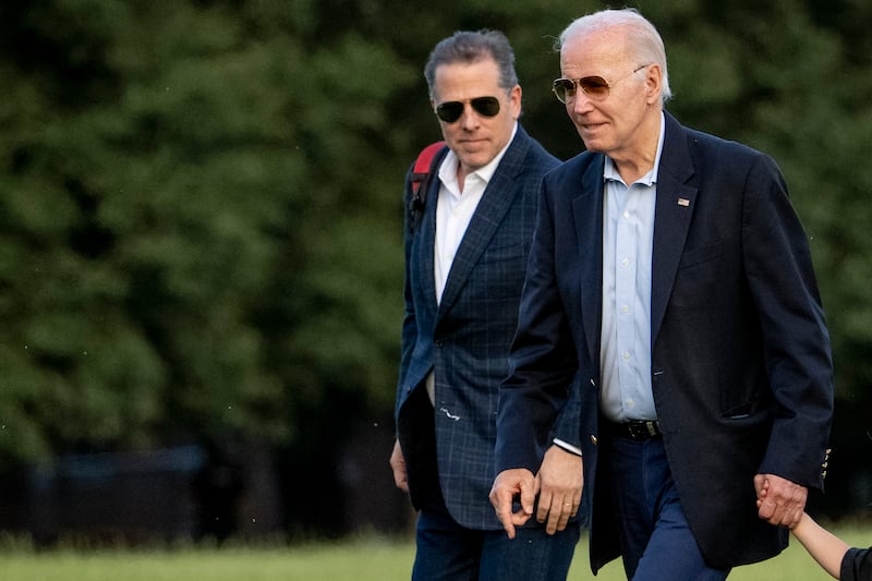 President Joe Biden and his son Hunter Biden walk together as they arrive at Fort McNair in Washington.