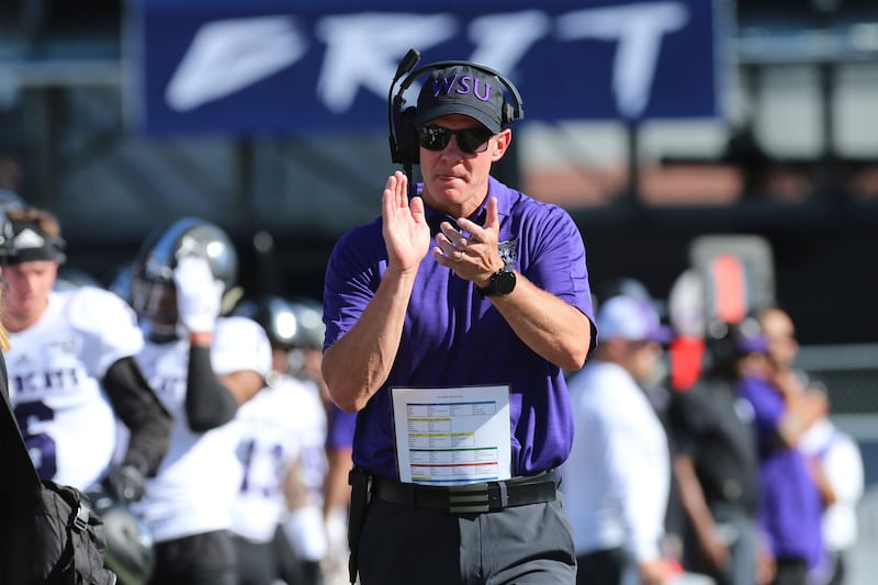 Weber State head coach Jay Hill rallies his team prior to kickoff against Nevada on Sept. 14, 2019.