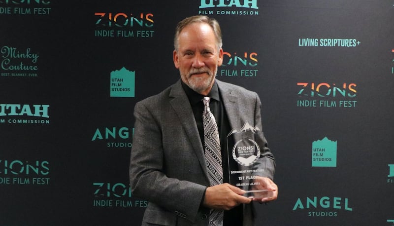 Director Blair Treu poses with the Zions Indie Film Fest prize for Best Documentary Feature for "Sharing Aloha."