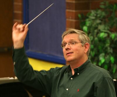 Sterling Poulson conducts the Choral Arts Society during a practice in Taylorsville on May 2, 2006.