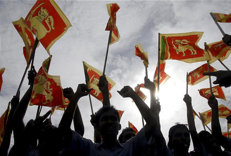 Sri Lankans wave their national flag during a victory rally Friday in Colombo to celebrate the defeat of the Tamil Tiger rebels in a civil war.