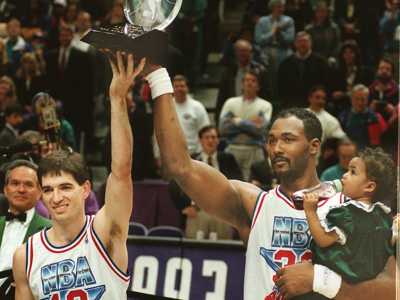 John Stockton and Karl Malone raise a trophy
