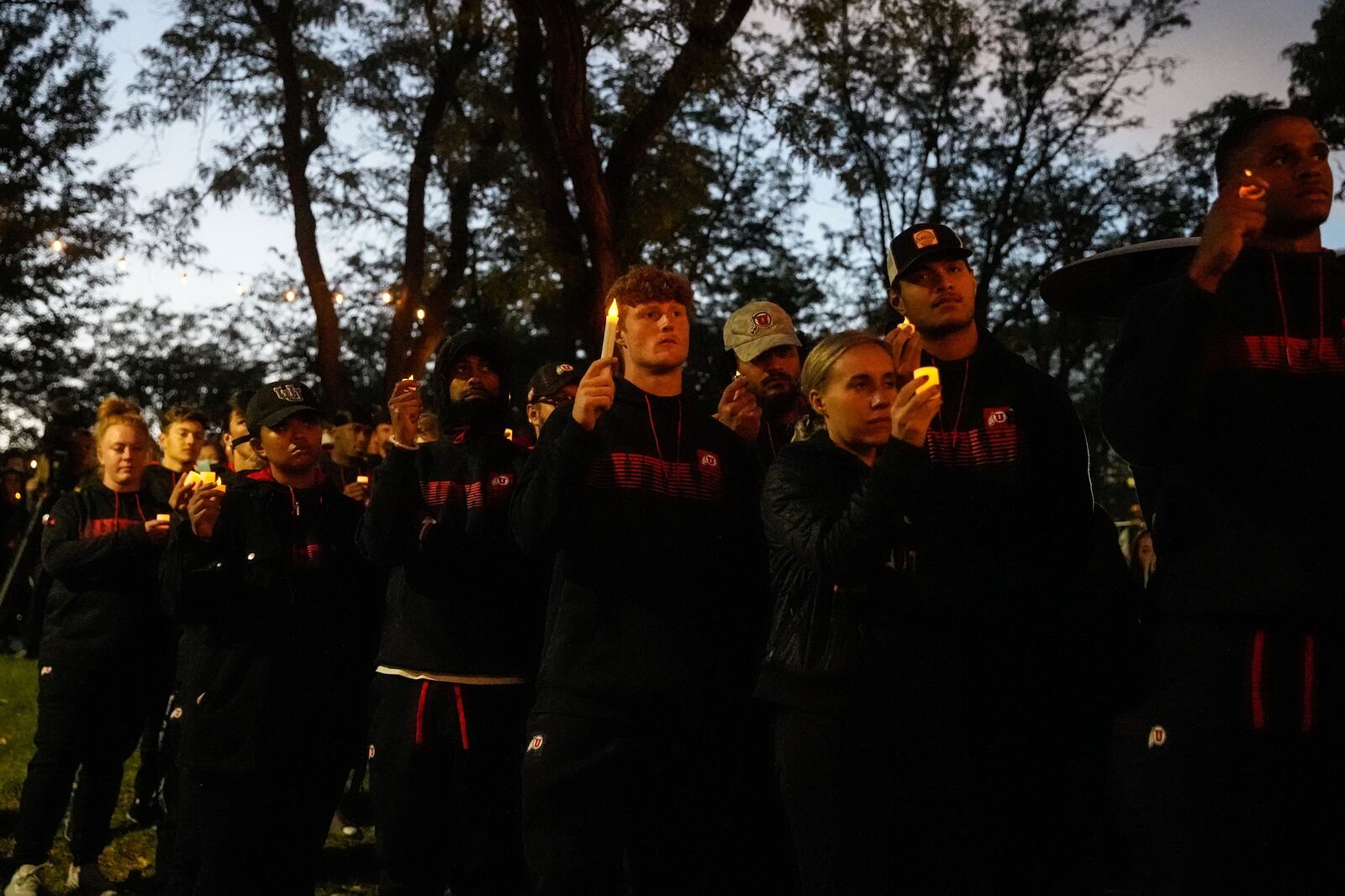 University of Utah athletes hold candles during a vigil for slain University of Utah football defensive back Aaron Lowe.