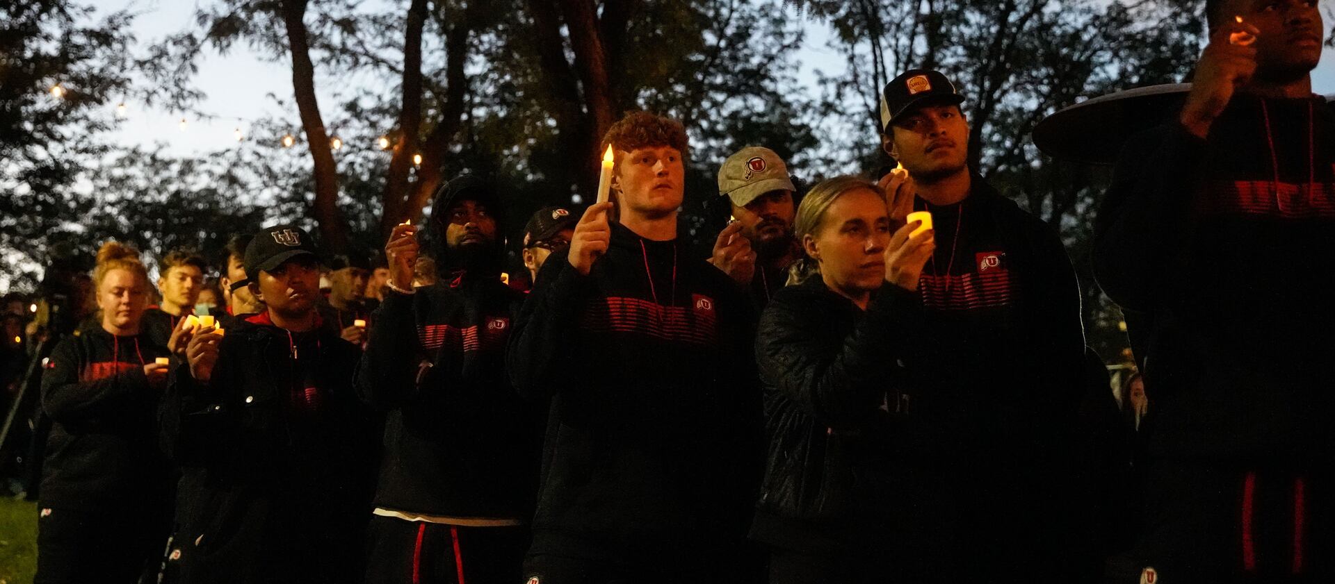 University of Utah athletes hold candles during a vigil for slain University of Utah football defensive back Aaron Lowe.