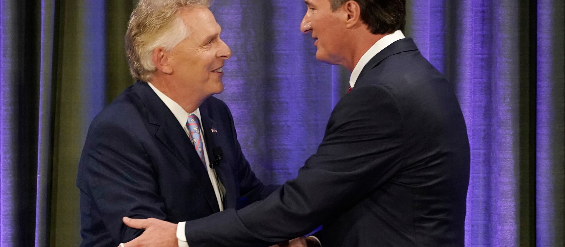 Democratic gubernatorial candidate former Gov. Terry McAuliffe, left, greets Republican challenger Glenn Youngkin before a debate.