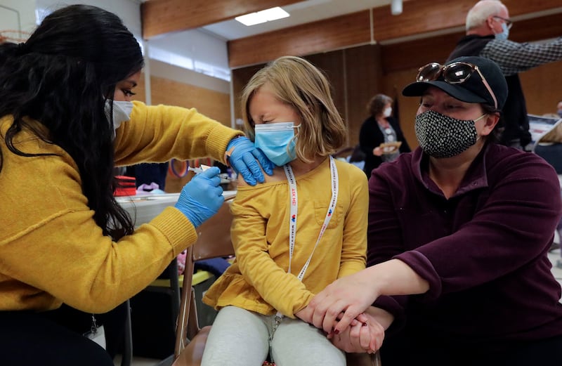 Claudia Ceron, a Salt Lake County Health Department health worker gives Etta Bastian a COVID-19 vaccination.