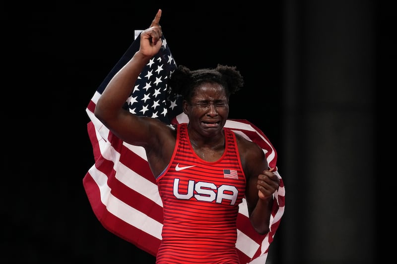 Tamyra Mensah-Stock holds the U.S. flag after winning Olympic gold in Tokyo.