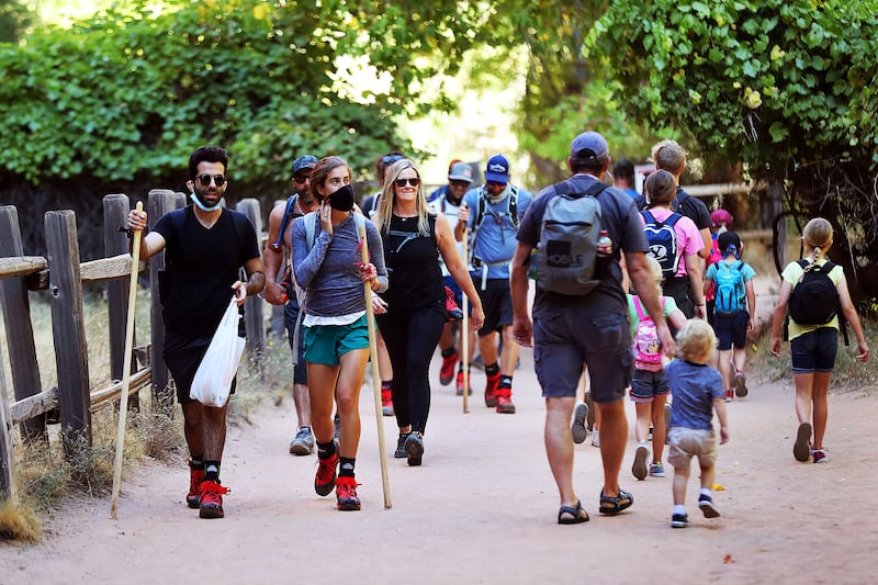 Visitors hike at Zion National Park in Utah.
