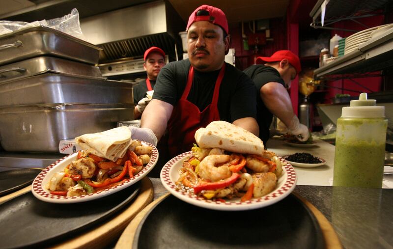 Carlos Velasquez prepares food at Red Iguana, near the new TRAX line on North Temple in Salt Lake City on April 5, 2013.