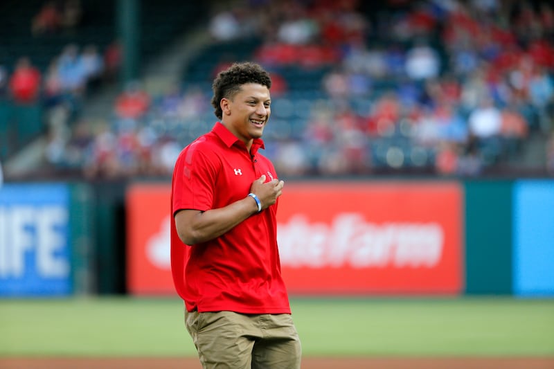 Patrick Mahomes smiles after throwing out the ceremonial first pitch before a game between the Toronto Blue Jays and Texas Rangers on May 13, 2016.