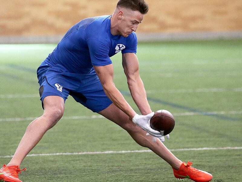 Mitch Mathews goes low to make a catch as BYU football players participate in Pro Day at their indoor practice facility in Provo Friday, March 25, 2016.
