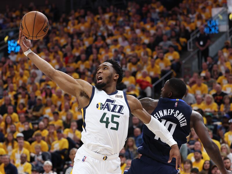 Utah Jazz guard Donovan Mitchell (45) grabs a rebound as he and Dallas Mavericks forward Dorian Finney-Smith (10) battle as the Utah Jazz and the Dallas Mavericks play.