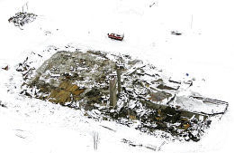 Only two chimneys are left standing in the rubble of the Electric Mountain Lodge near Paonia, Colo. Three children were killed in the blast.