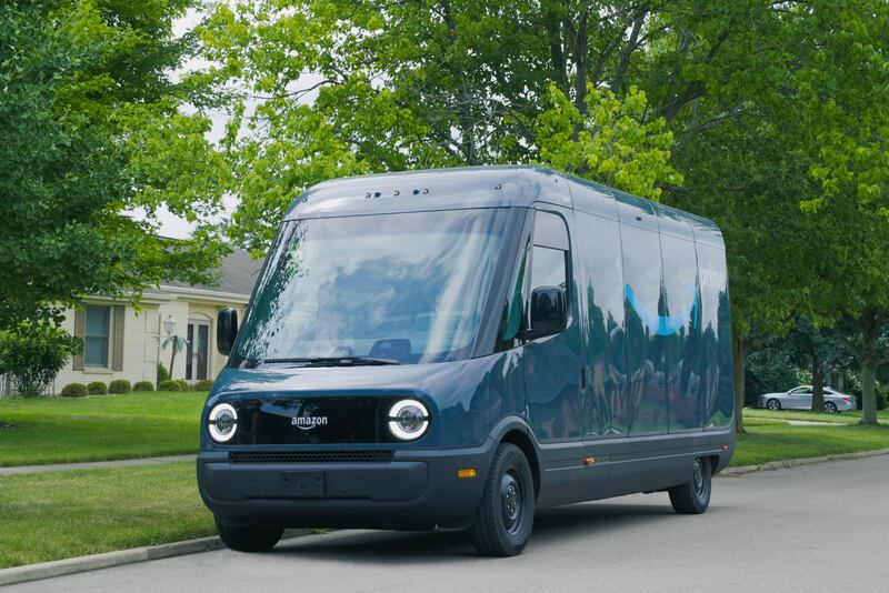 A photo of Rivian’s electric delivery van for Amazon parked on the street.