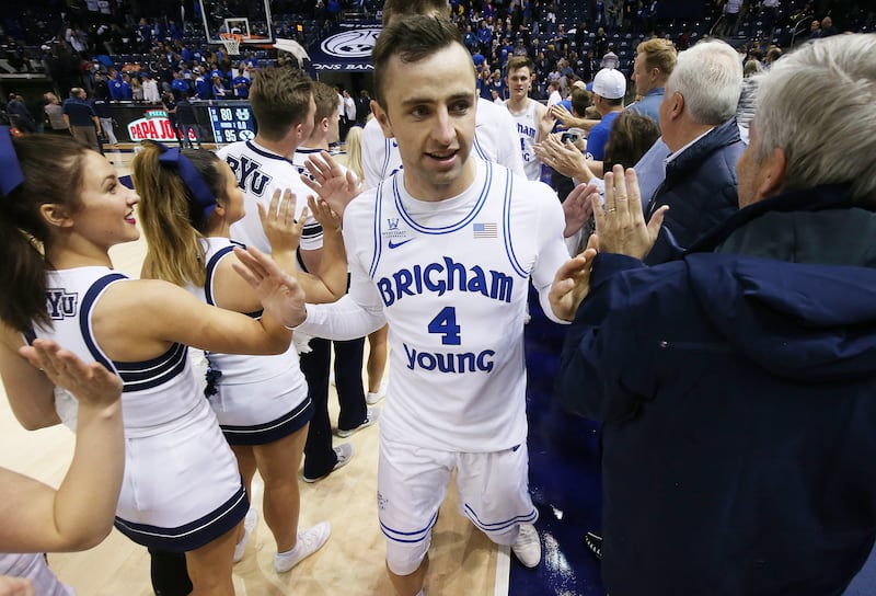 Brigham Young Cougars guard Nick Emery (4) high-fives fans after the USU game.