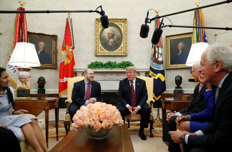 President Donald Trump, right, talks with Joshua Holt, who was recently released from a prison in Venezuela, in the Oval Office of the White House, Saturday, May 26, 2018, in Washington.
