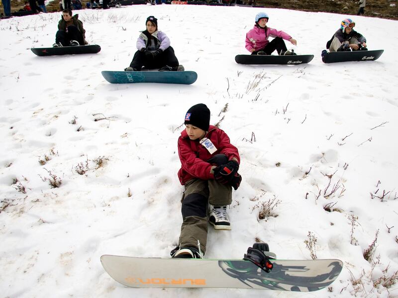 Young snowboarders wait for instruction from their teacher at the first day of snowboard school at Snowbird Ski Resort in 2007.